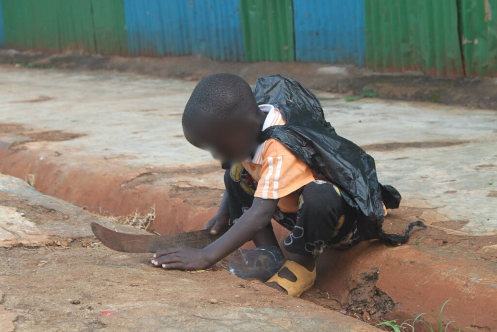 A poor African boy from an orphanage in Kenya playing
