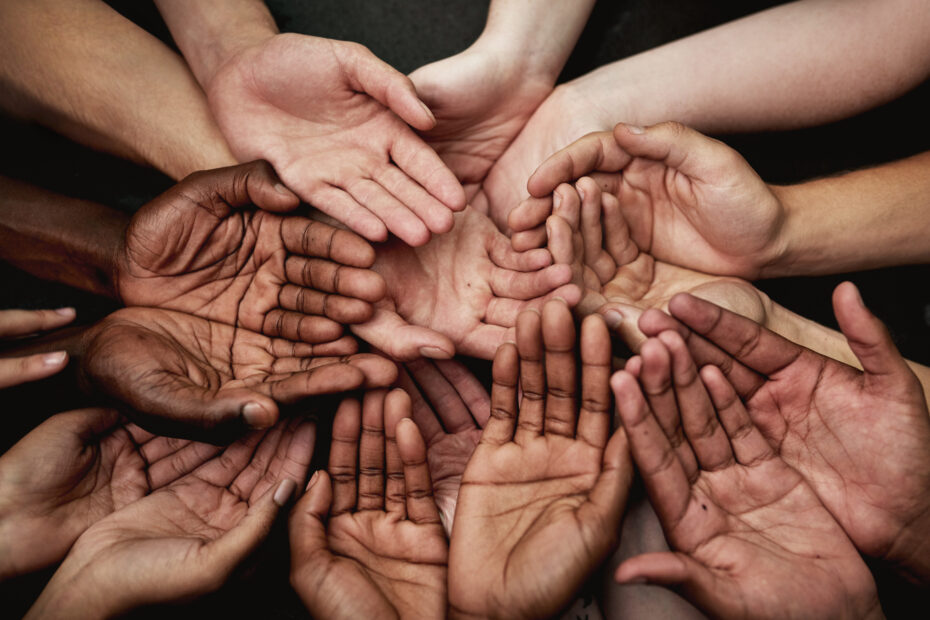 a diverse group of hands held together to symbolize human rights