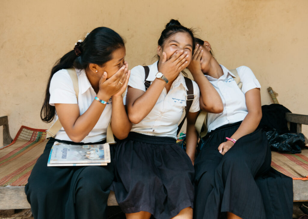 Cambodian girls laughing with support from Hagar International 