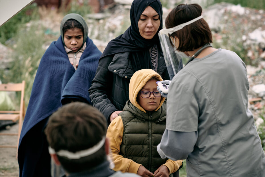 Checking Temperature Of Refugee Child